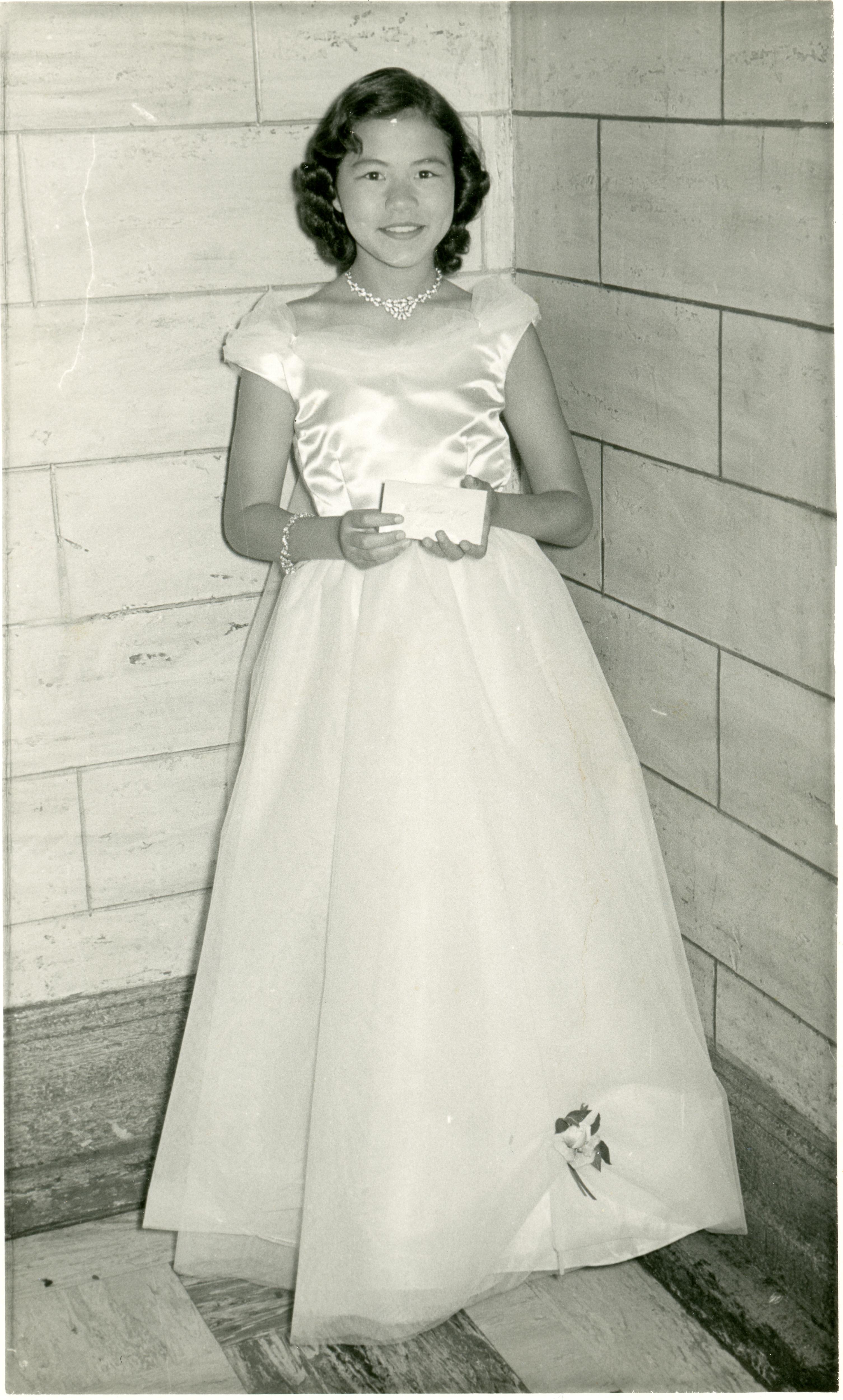 Black and white photo of a woman wearing a deb gown.