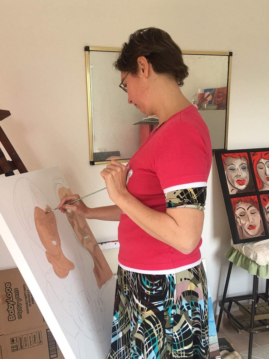 Ros Robinson painting in her Mount Tamborine studio