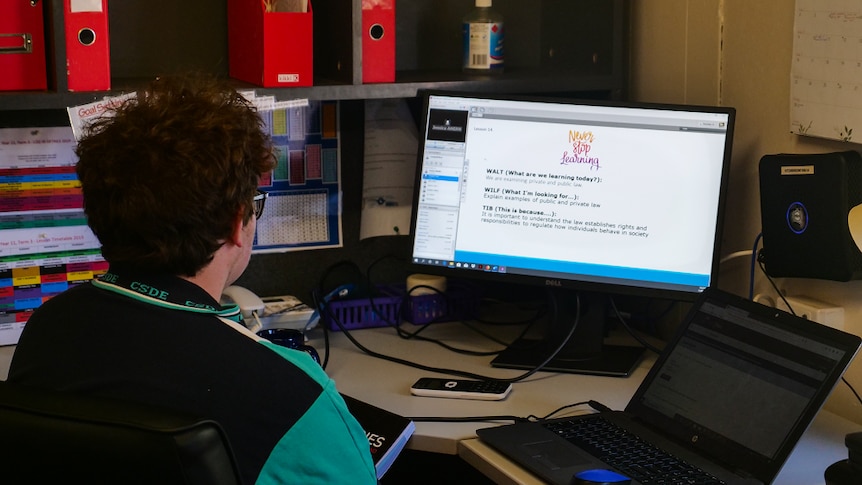 Campbell West sits at his desk looking at a computer screen