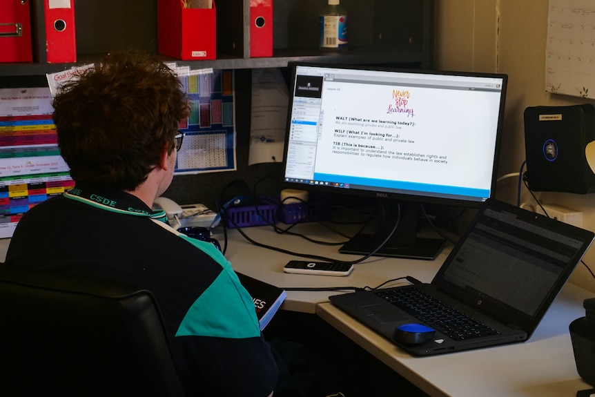 Campbell West sits at his desk looking at a computer screen