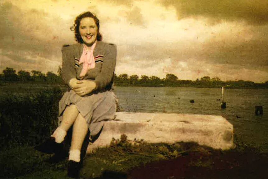 Avice Marsh, pictured as a young woman, sits in a paddock