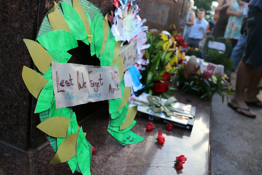 Wreaths and other signs of remembrance are laid at the Darwin Cenotaph.