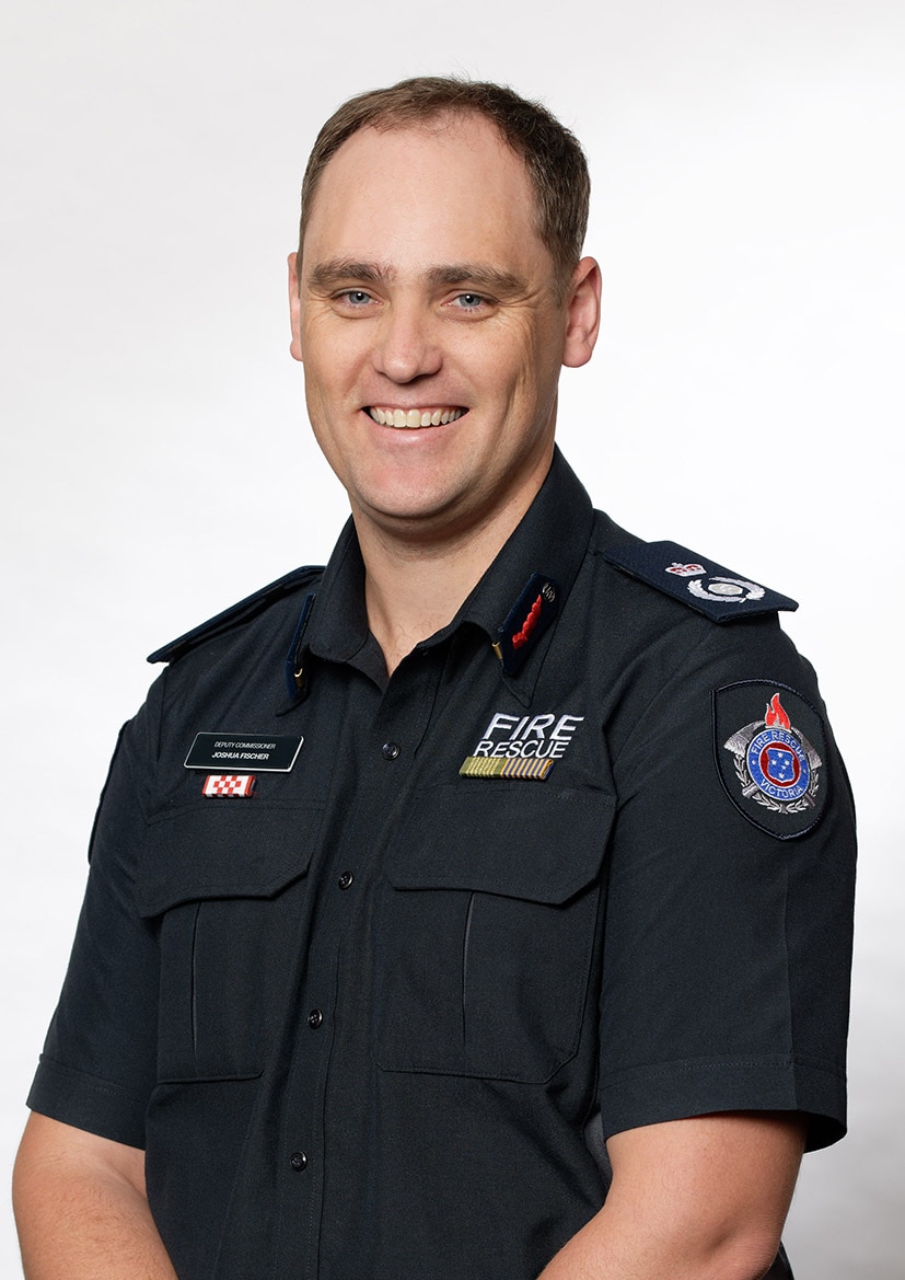 image of middle-aged man in fire fighter uniform smiling in corporate headshot