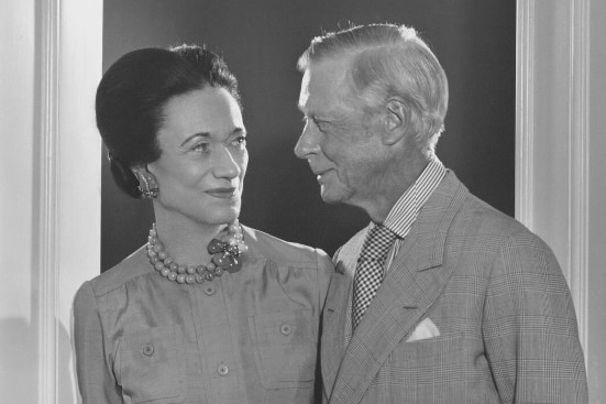 A black and white photograph of a couple looking lovingly at each other.
