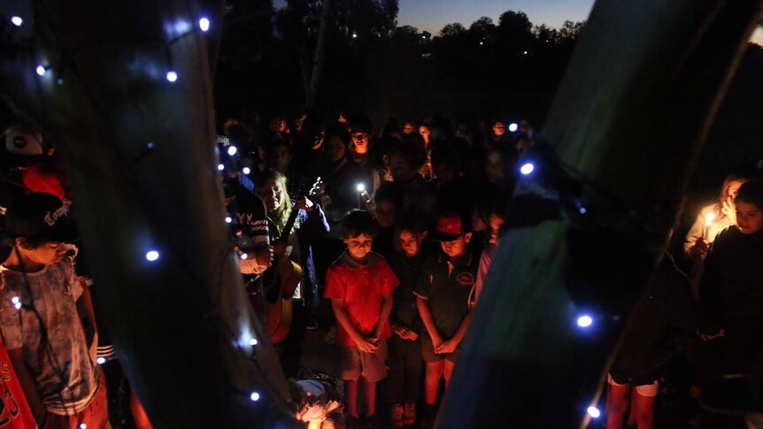 Mourners stand at a vigil held in Kalgoorlie to mourn the death of Elijah Doughty.