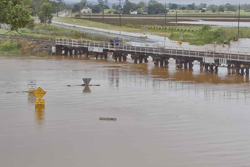 Flooding at Grantham railway bridge with brown water not far from the bottom of the bridge