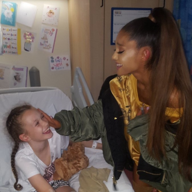 Ariana Grande reaches out to young fan Jaden Farrell Mann at The Royal Manchester Children's Hospital.