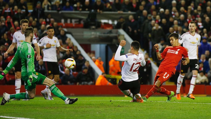 Roberto Firmino scores the second goal for Liverpool against Manchester United in the Europa League.