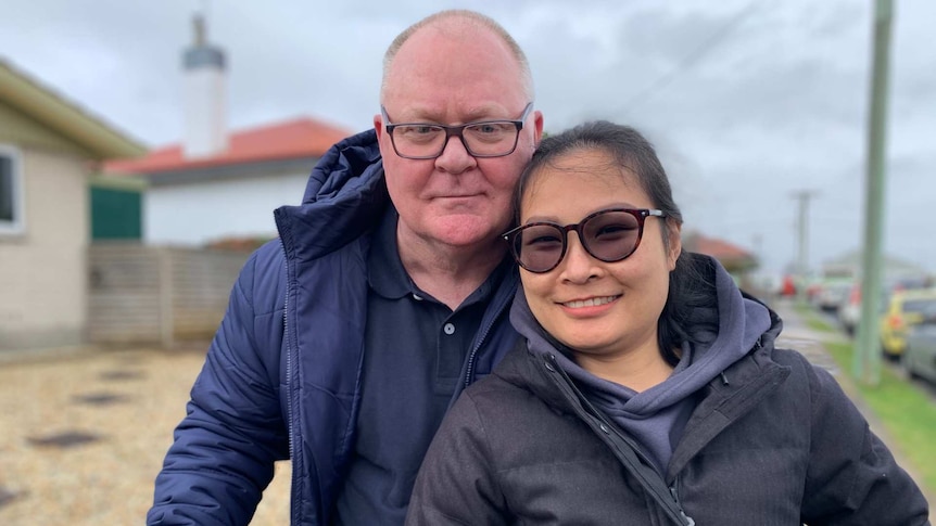 A man and woman standing together in front of the house they just bought, 3 Sep 2020.