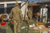 Army troops help to clean up in the town of Winfield