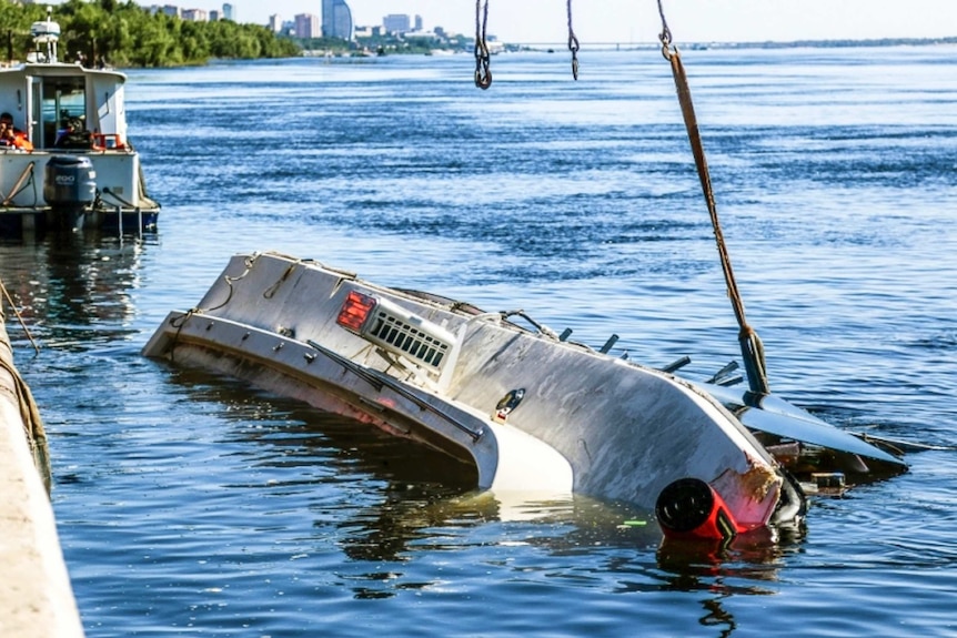 Overturned boat sits upside-down after a collision on the Volga River