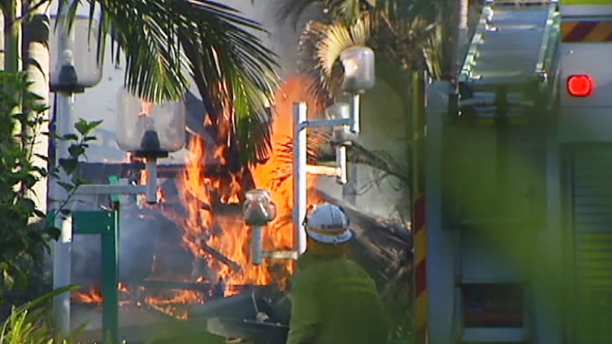 A fireman battles flames in a burning building at a residential care facility