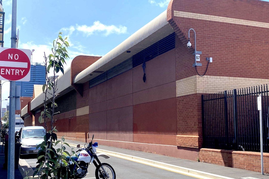 An item of clothing hangs from the exterior of the Adelaide Remand Centre.