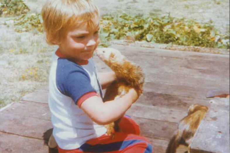 Daniel Bowden as a child holding a ferret