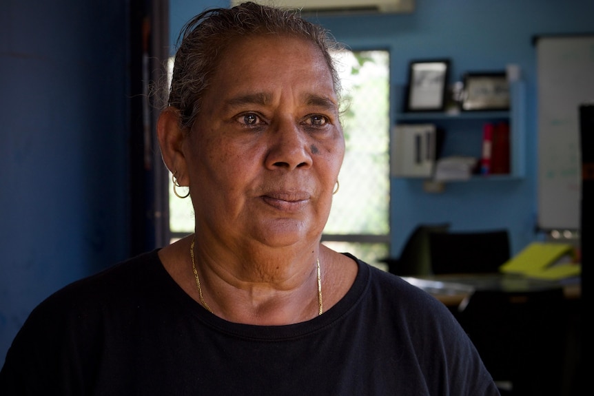 A portrait photo of an Aboriginal woman wearing a black t-shirt