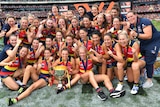 The Adelaide Crows celebrate with the AFLW Premiership cup