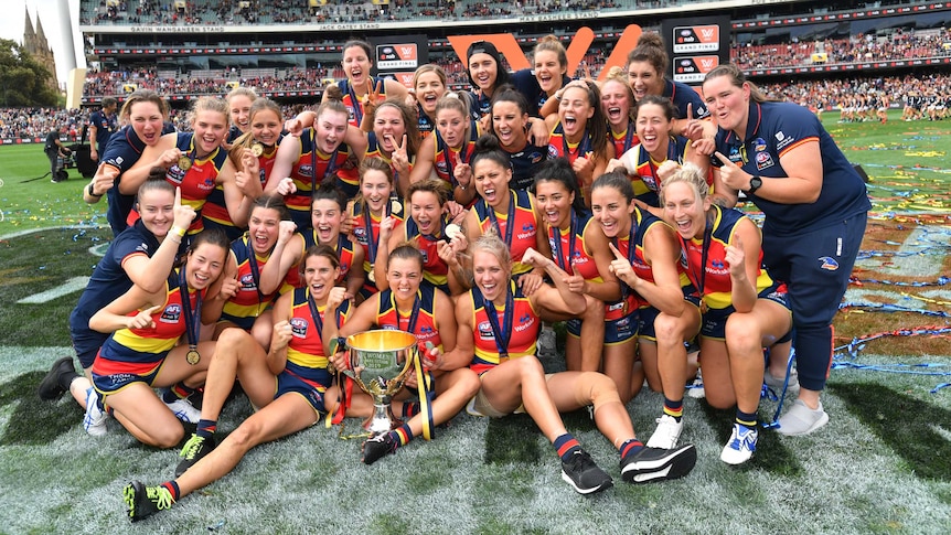 The Adelaide Crows celebrate with the AFLW Premiership cup