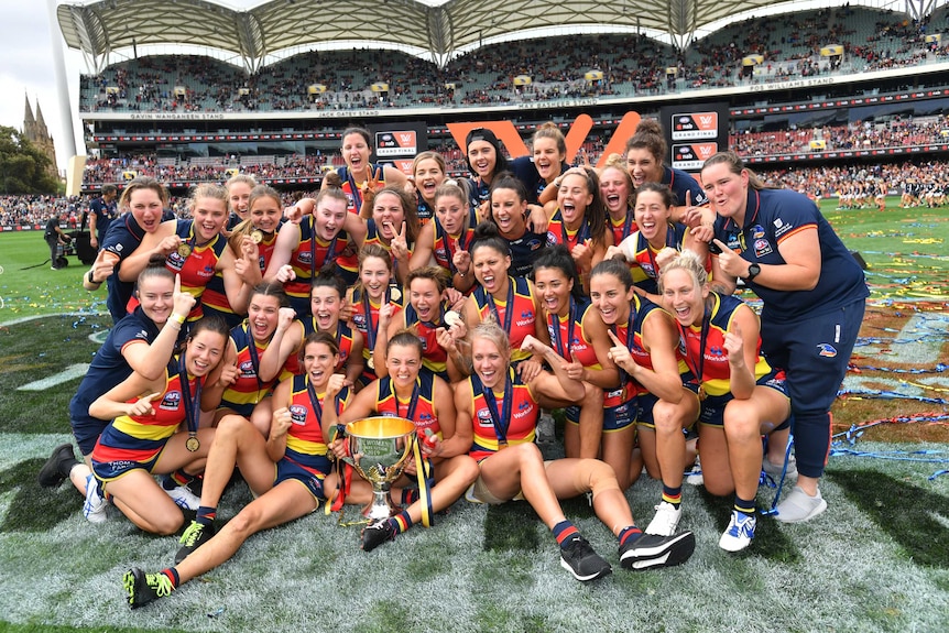 The Adelaide Crows celebrate with the AFLW Premiership cup