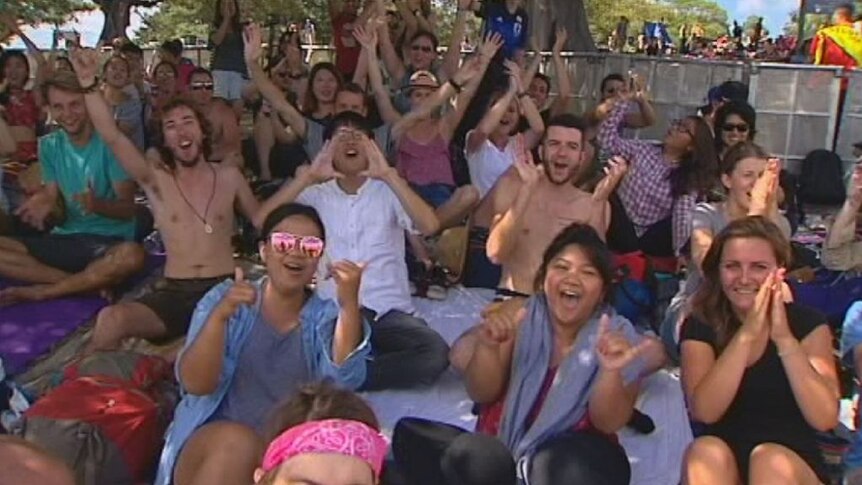 Revellers run down the hill to Mrs Macquarie's Chair to secure best vantage spot
