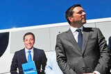 Matthew Guy stands in front of a bus bearing his image and the words 'Get back in control'.