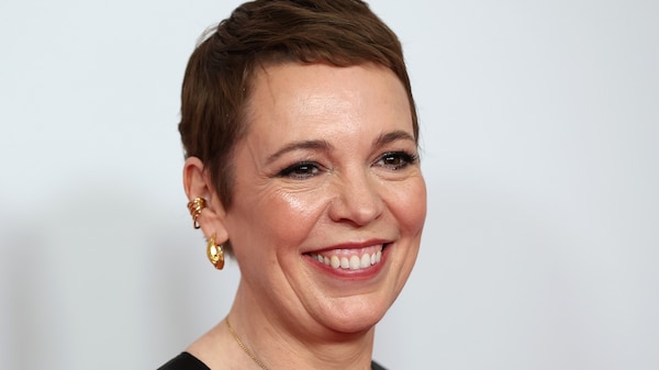 A middle-aged woman with cropped brown hair and a broad smile