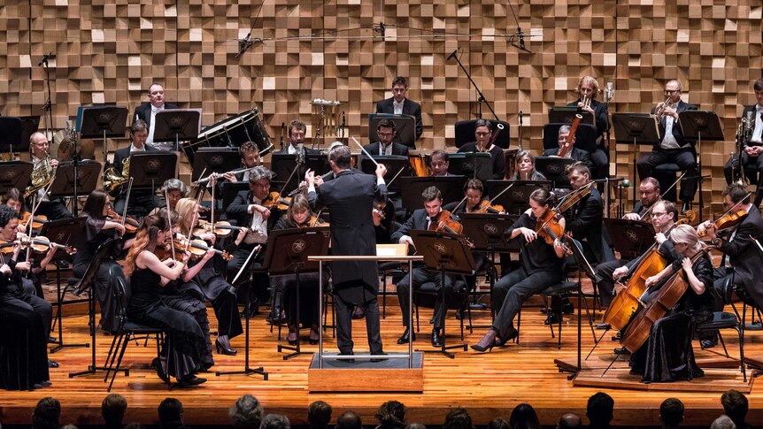 An orchestra perform a music piece
