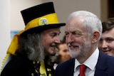Labour leader Jeremy Corbyn at a counting centre in London, walks past a member of the raving loony party