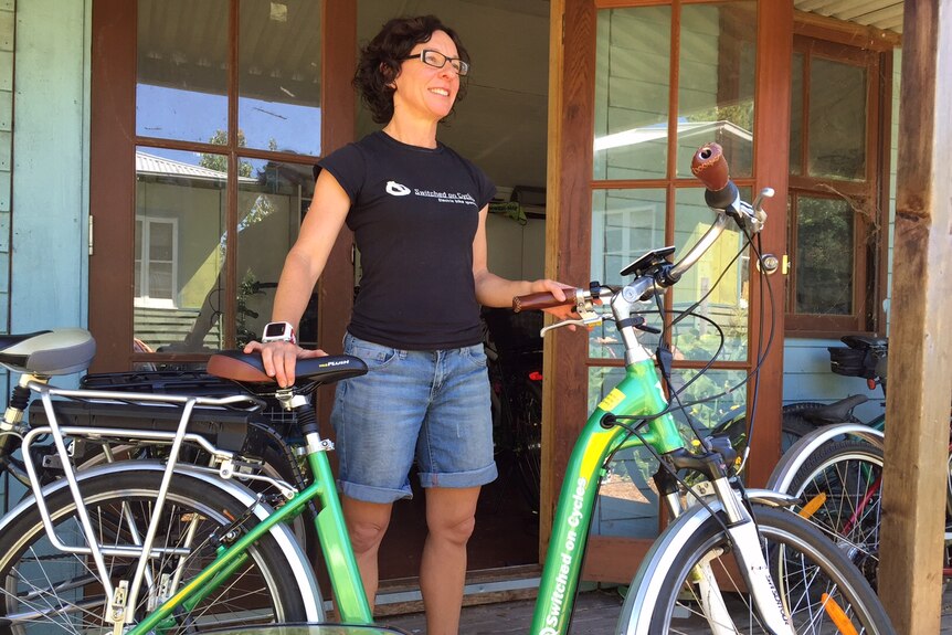 Bicycle retailer Simone Annis poses with an electronic bike.