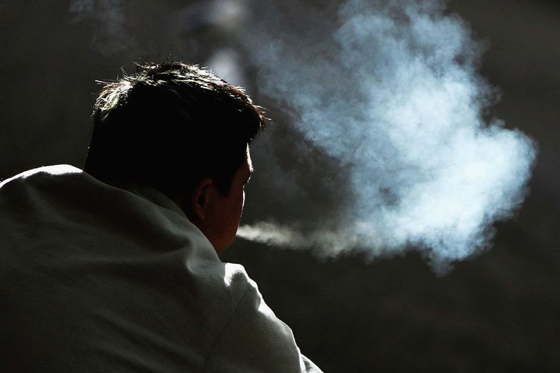 Silhouette of a man smoking a cigarette