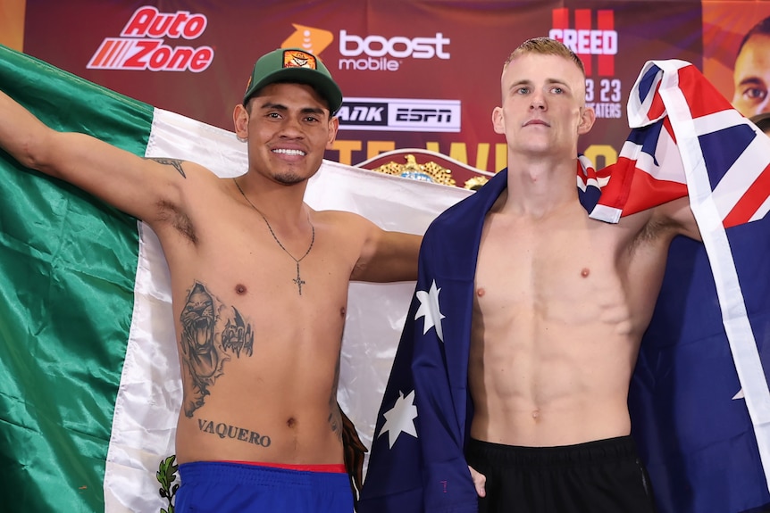 Emanuel Navarrete and Liam Wilson stand, shirtless, holding Mexico and Australia flags behind them