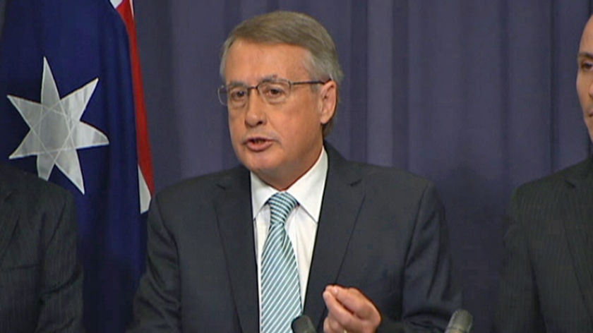 TV Still of Wayne Swan announcing the Government's plan to reform the banking sector.