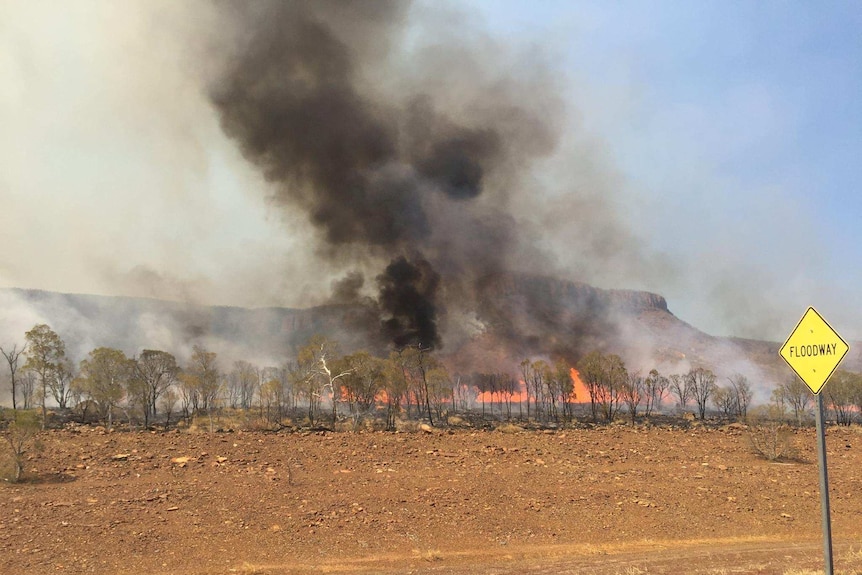 A photo of fire and smoke sweeping through the Cockburn Ranges in the East Kimberley