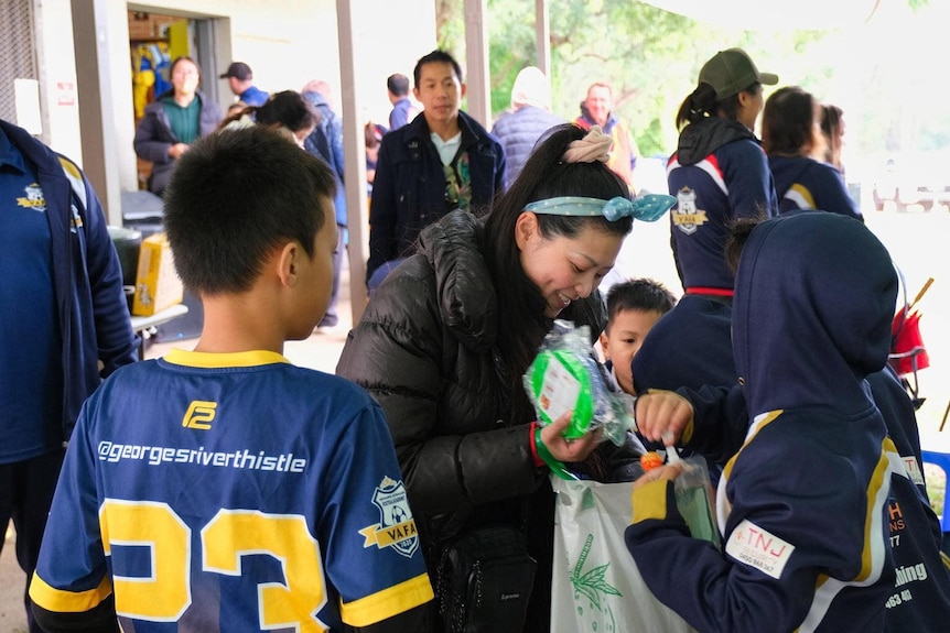 A coaching session with soccer kids and an adult woman 