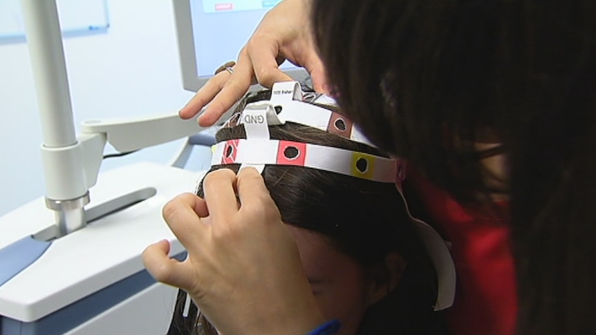 A woman gets her brain stimulated in a laboratory as part of a study