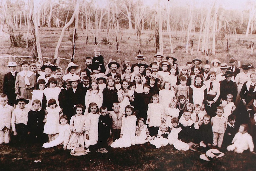 B&W historical photo of children and adults gathered at picnic in bushland at Maroon.