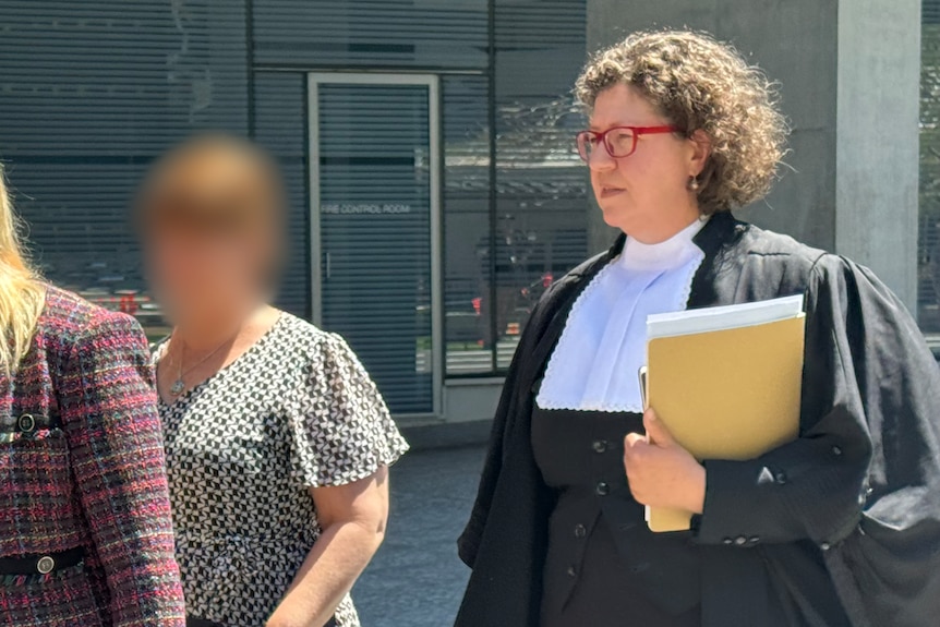 a barrister and a woman beside her with her face blurred