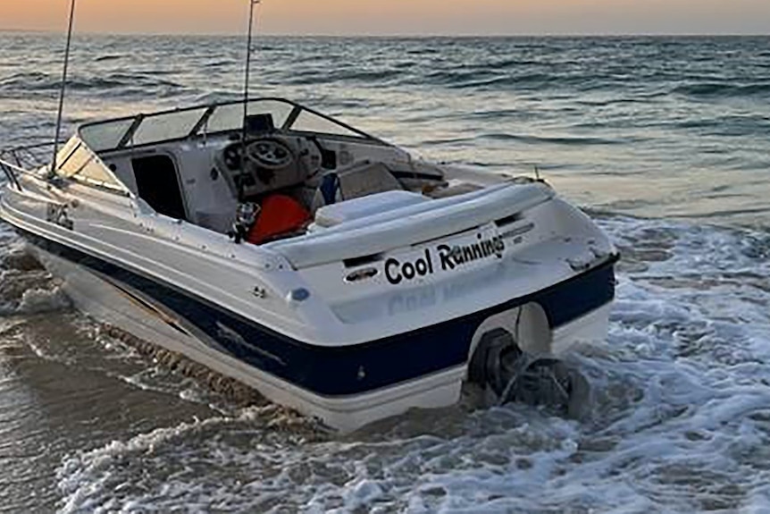 A small boat with a "Cool Runnings" sign.