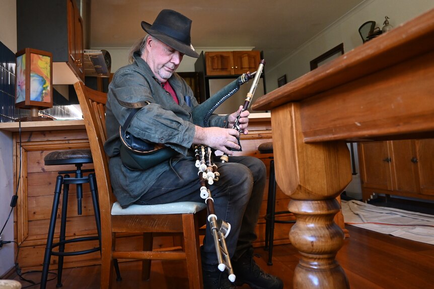 A man playing the Uilleann pipes