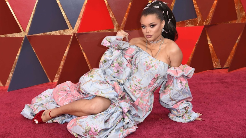 Singer Andra Day lays on the red carpet.