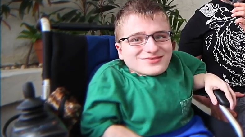 A young man in a wheelchair