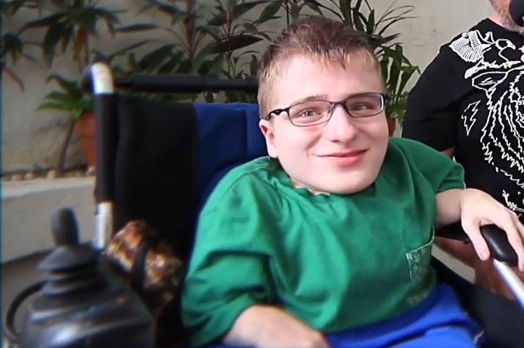 A young man in a wheelchair