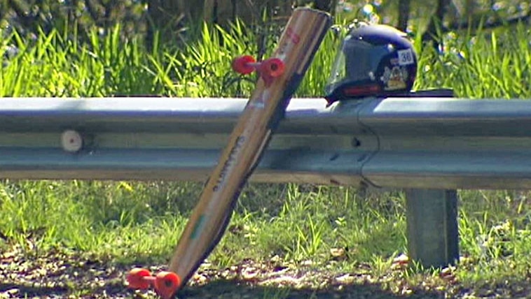 TV still of luge board and helmet fatal accident scene on Mt Coot-tha on December 17, 2011.
