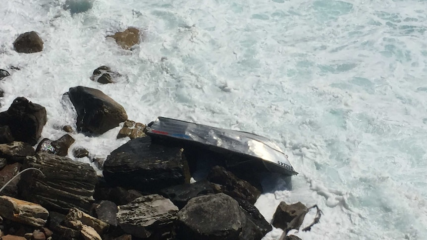 Boat washed up on rocks