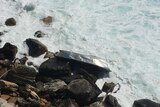 Boat washed up on rocks