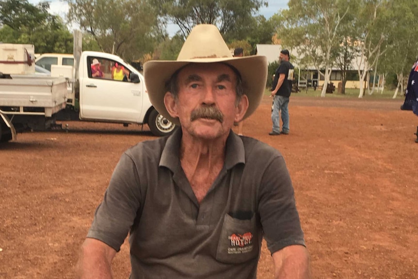 A man with a thick moustache wearing a dusty Akubra sits on a motorised Esky