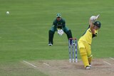 Nicole Bolton hitting the ball down the ground for Australia against South Africa.