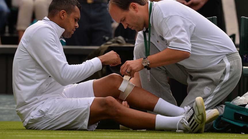 Jo-Wilfried Tsonga receives treatment at Wimbledon