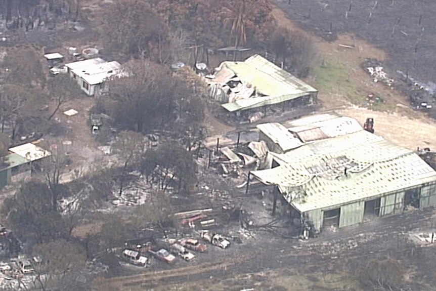 Aerial image of cars and bulldings gutted by bushfire