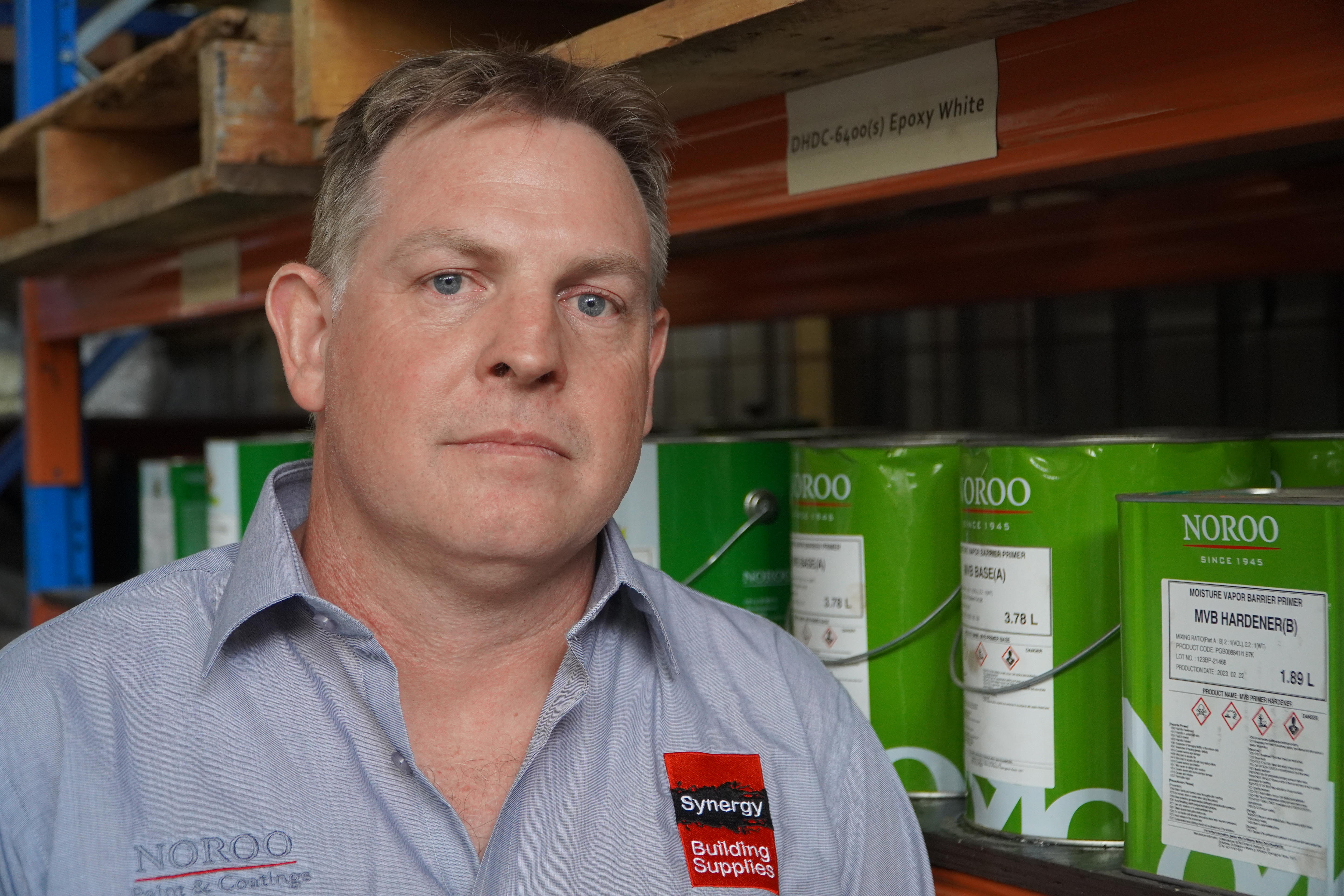 A man named Andrew Mutch looks straight at the camera. 