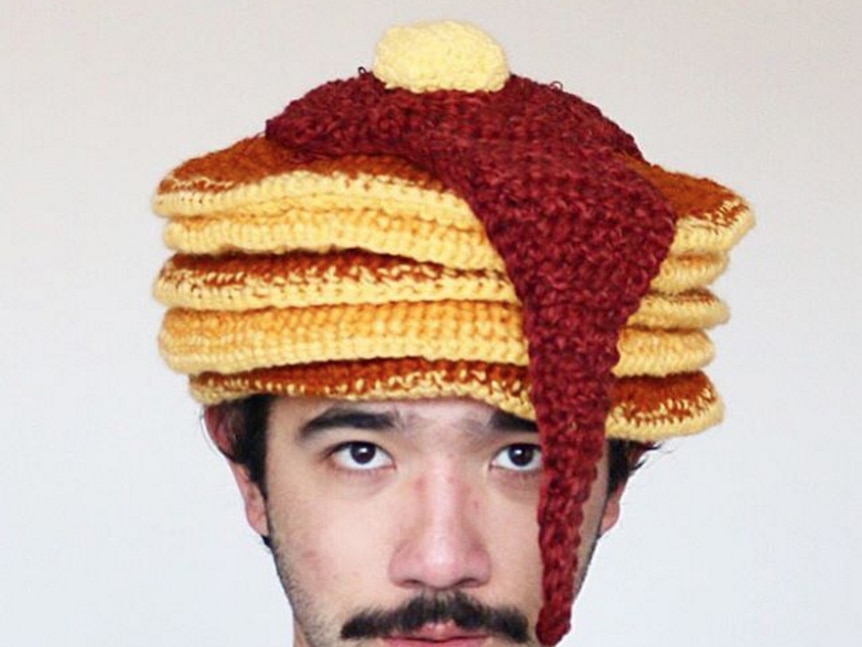 Phil Ferguson wearing a crocheted pancakes hat.